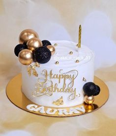 a birthday cake with gold and black decorations