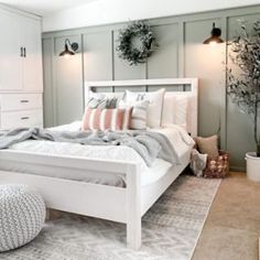 a white bed sitting in a bedroom on top of a rug