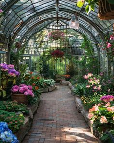 the inside of a greenhouse filled with lots of flowers