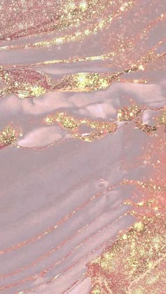 an aerial view of the earth's surface in gold and pink