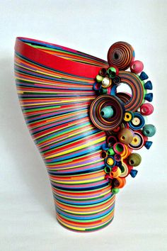 a colorful vase with lots of different colored beads on it