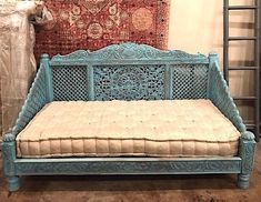 a blue bench sitting next to a red rug