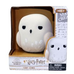 a white and black toy in a box on a white background with the words harry potter written across it