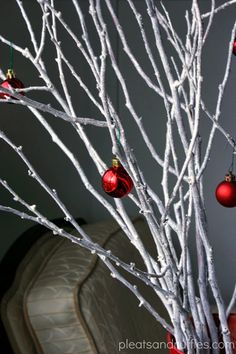 a white tree with ornaments hanging from it's branches