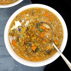 two white bowls filled with soup on top of a black table next to each other