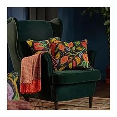 a green chair with colorful pillows on it