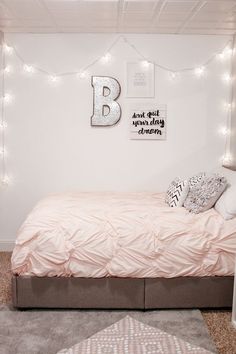 a bedroom with lights strung above the bed