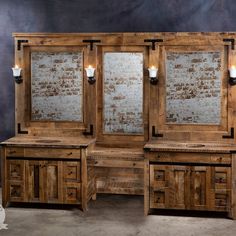 a wooden desk with two mirrors and lights on it's sides, in front of a brick wall