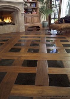 a living room filled with furniture and a fire place in the middle of the floor