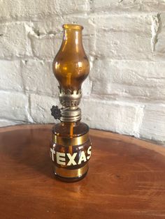 a small glass bottle sitting on top of a wooden table