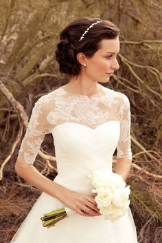 a woman in a wedding dress holding a bouquet