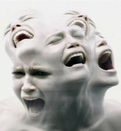 two white mannequins with their mouths open in front of the camera,