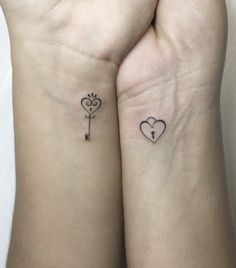 two small tattoos on both wrists that have hearts and key attached to each other