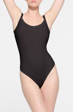 This fitted bodysuit from Kim Kardashian's SKIMS gives the look of a tucked-in camisole—making it perfect for everyday wear. Snap closure Scoop neck Sleeveless 90% cotton, 10% spandex Machine wash, tumble dry Imported Black Seamless Fitted Leotard, Micro-elastic Shapewear Leotard, Solid Color Second-skin Bodysuit For Dancewear, Black Seamless Second-skin Leotard, Black Seamless Leotard, Full Coverage Stretch Leotard In Solid Color, Solid Full Coverage Stretch Leotard, Solid Stretch Full Coverage Leotard, Sporty Micro-elastic Black Bodysuit