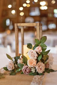 a table topped with a candle and flowers