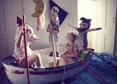 three children are sitting in a boat with pirate decorations