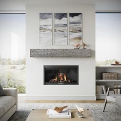 a living room with a fire place in the center and two paintings on the wall