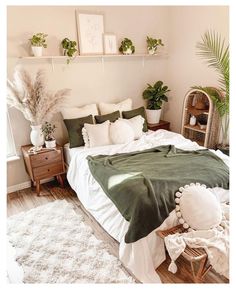 a bed sitting in a bedroom next to a window with potted plants on top of it