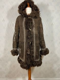 Brown Fur Coat With Feather Trim, Brown Long Sleeve Fur Coat With Feather Trim, Sheepskin Long Fur Coat For Cold Weather, Sheepskin Long Coat For Cold Weather, Hooded Brown Sheepskin Fur Coat, Winter Sheepskin Outerwear With Feather Trim, Bohemian Brown Fur Coat With Faux Fur Lining, Penny Lane Coat, Daisy Jones