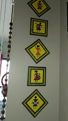 the wall is decorated with yellow and green designs on it's sides, along with beaded necklaces