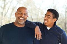 an older man and young boy smiling for the camera