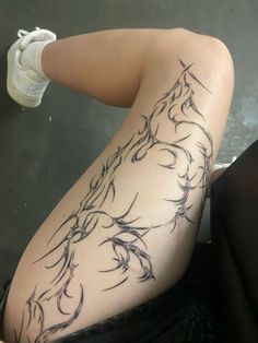 a woman's legs with tattoos on them