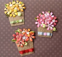 three different types of paper flowers on a table