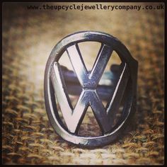 a vw logo ring sitting on top of a piece of cloth covered flooring