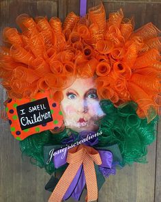 an orange and green wreath with the words i smell children on it