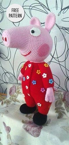 a knitted peppa pig wearing a red sweater and flower pants with the words free pattern