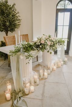 a table with candles and flowers on it