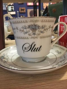 a cup and saucer sitting on top of a wooden table