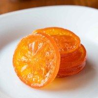 an orange sliced in half on a white plate