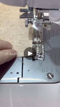 someone is using a sewing machine to sew something on the fabric that has been stitched together