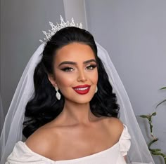 a woman wearing a wedding veil and tiara