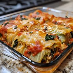 a casserole dish filled with vegetables and sauce