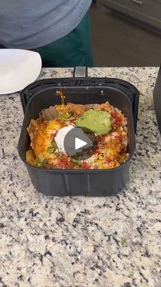 a black container filled with food on top of a counter