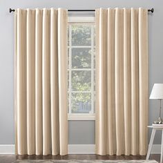 the curtains in this room are lined with light brown drapes and one is open