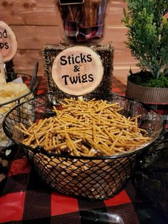 there is a basket full of sticks and twines in the center of this table