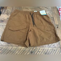 These Shorts Are Perfect For Casual Occasions And Are Made Of High-Quality Nylon Material That Ensures Durability And Comfort. The Drawstring Closure And 5-Pocket Design Provide Ample Storage Space For Your Essentials. These Shorts Are Designed To Fit Perfectly On Men With A Waist Size Of 36 Inches And Are Ideal For Summer And Spring Seasons. The Cargo Style And Brown Color Add To The Overall Aesthetic Of The Shorts. Summer Utility Hiking Bottoms, Summer Cargo Style Bottoms For Hiking, Summer Utility Nylon Bottoms, Utility Shorts With Elastic Waistband For Outdoor Activities, Stretch Casual Hiking Shorts, Brown Summer Shorts For Outdoor, Nylon Utility Cargo Shorts, Utility Nylon Cargo Shorts With Elastic Waistband, Utility Nylon Shorts With Pockets