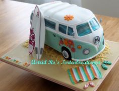 a cake shaped like a van with a surfboard on top