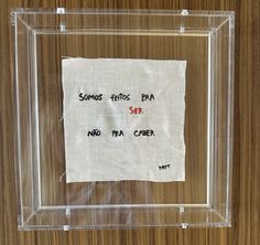 a piece of paper with some writing on it in a clear frame that is taped to the wall