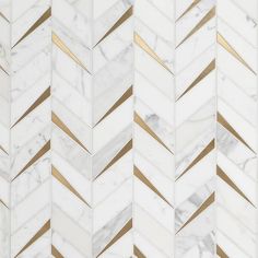 white and gold herringbone marble tile with golden lines on the edges, in an angled pattern