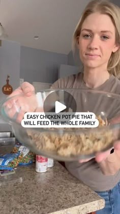 a woman holding a glass bowl with food in it and the words easy chicken pot pie that will feed the whole family