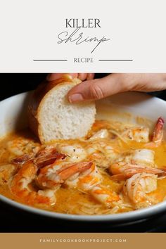 a person dipping some bread into a bowl of shrimp soup