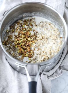 a pot filled with rice and nuts on top of a towel