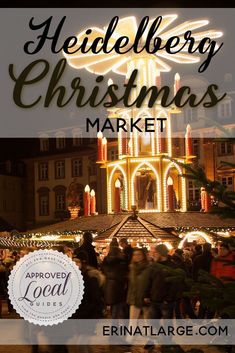 people are walking around in front of a building with christmas lights on it and the words heidelberg christmas market