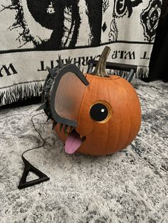 a pumpkin with its mouth open sitting on the ground