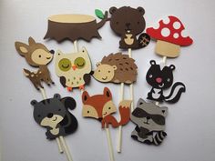 there are many different animals on the stick together, and one is holding a mushroom