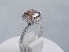 an engagement ring with a brown diamond surrounded by white diamonds